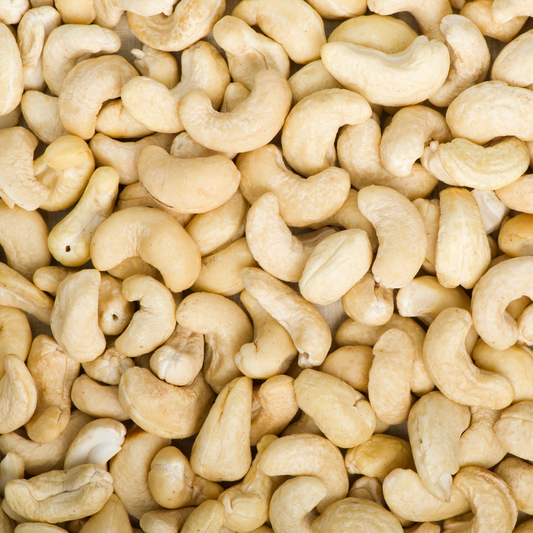 close-up of raw organic cashew nuts showing creamy colour and curved shape