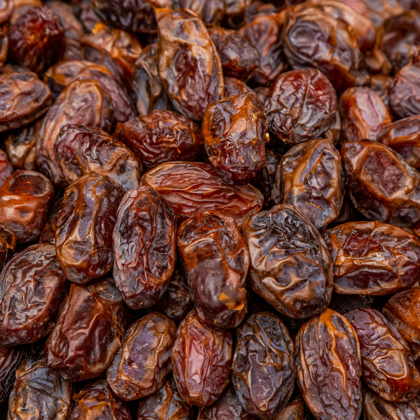 close-up of organic pitted sayer dates showing amber-brown colour and chewy semi-dry texture